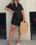 Black denim-style casual dress with button placket, short sleeves, and frayed hem