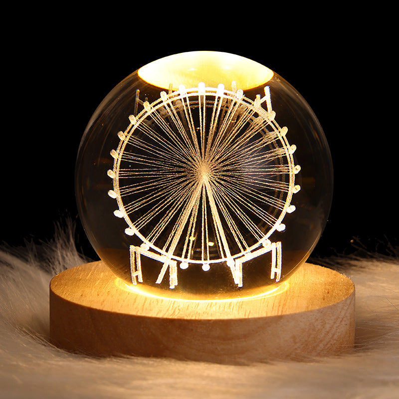 Luminous crystal ball with Ferris wheel light pattern on a wooden base