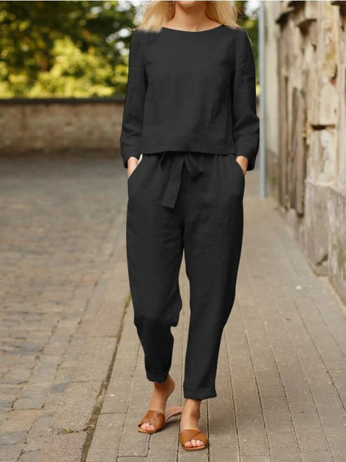 Black two-piece set with long sleeves and tie-front tapered jogger pants.