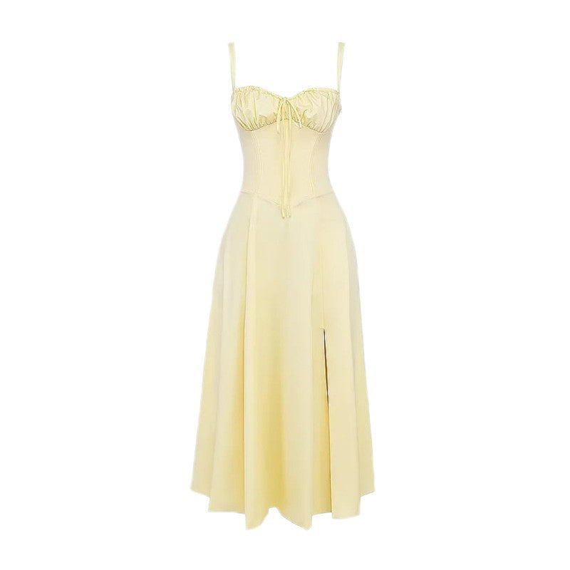 Light yellow mid-length dress with spaghetti straps, cinched waist, and A-line skirt