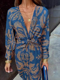 Blue patterned summer dress with V-neck wrap and knotted waist tie, long sleeves