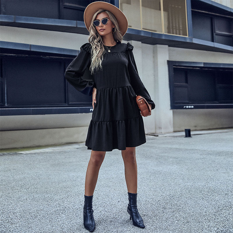 Black tiered mini dress with long sleeves and layered skirt hem