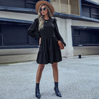 Black tiered mini dress with long sleeves and layered skirt hem