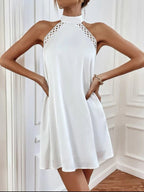 White halter mini dress with sleeveless cut and lace-trim high collar