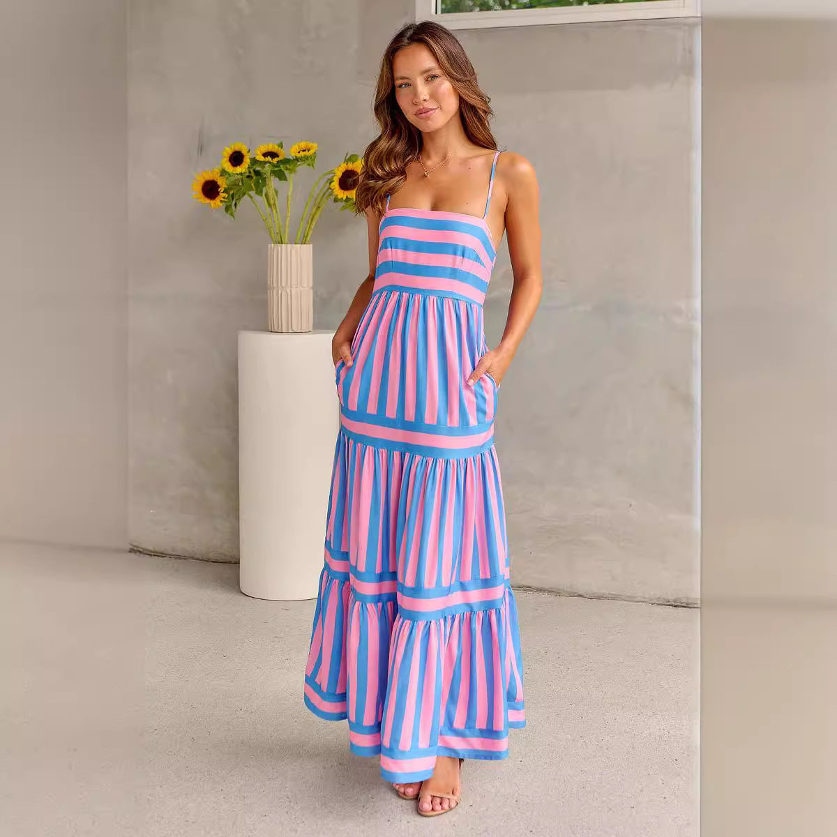 Pink and blue striped tiered maxi dress with spaghetti straps and tiered skirt