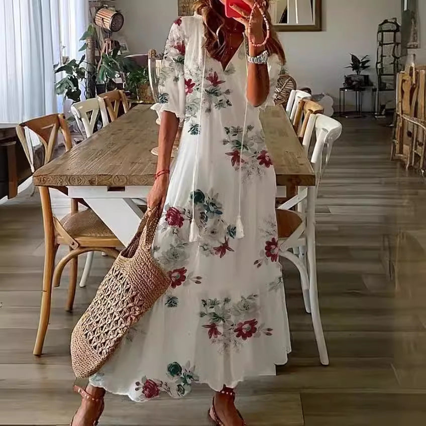 White boho maxi dress with red and green floral print and gathered puff sleeves