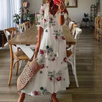 White boho maxi dress with red and green floral print and gathered puff sleeves