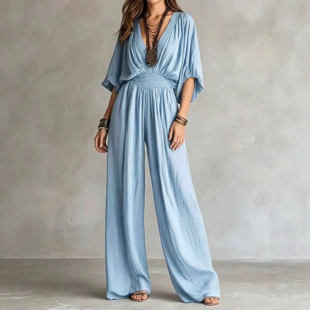Light blue V-neck wide-leg jumpsuit with elastic waist and draped short sleeves