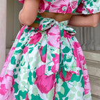 Pink floral casual summer dress with puff sleeves, tie-front waist, and full skirt