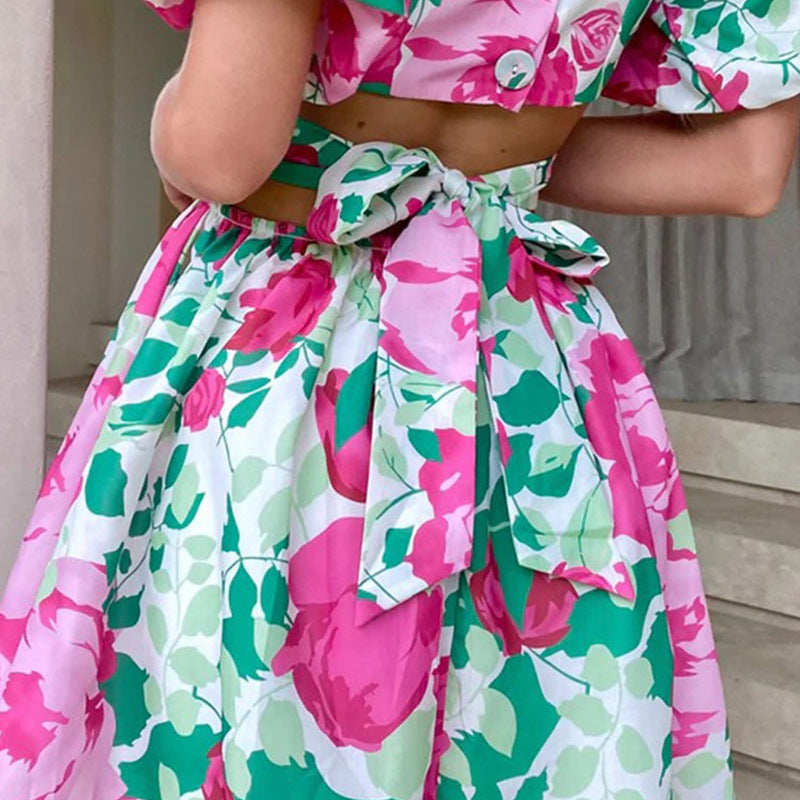 Pink floral casual summer dress with puff sleeves, tie-front waist, and full skirt
