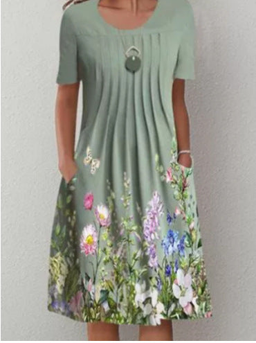 Casual floral dress in sage green with short sleeves, keyhole neckline, and multicolor flowers