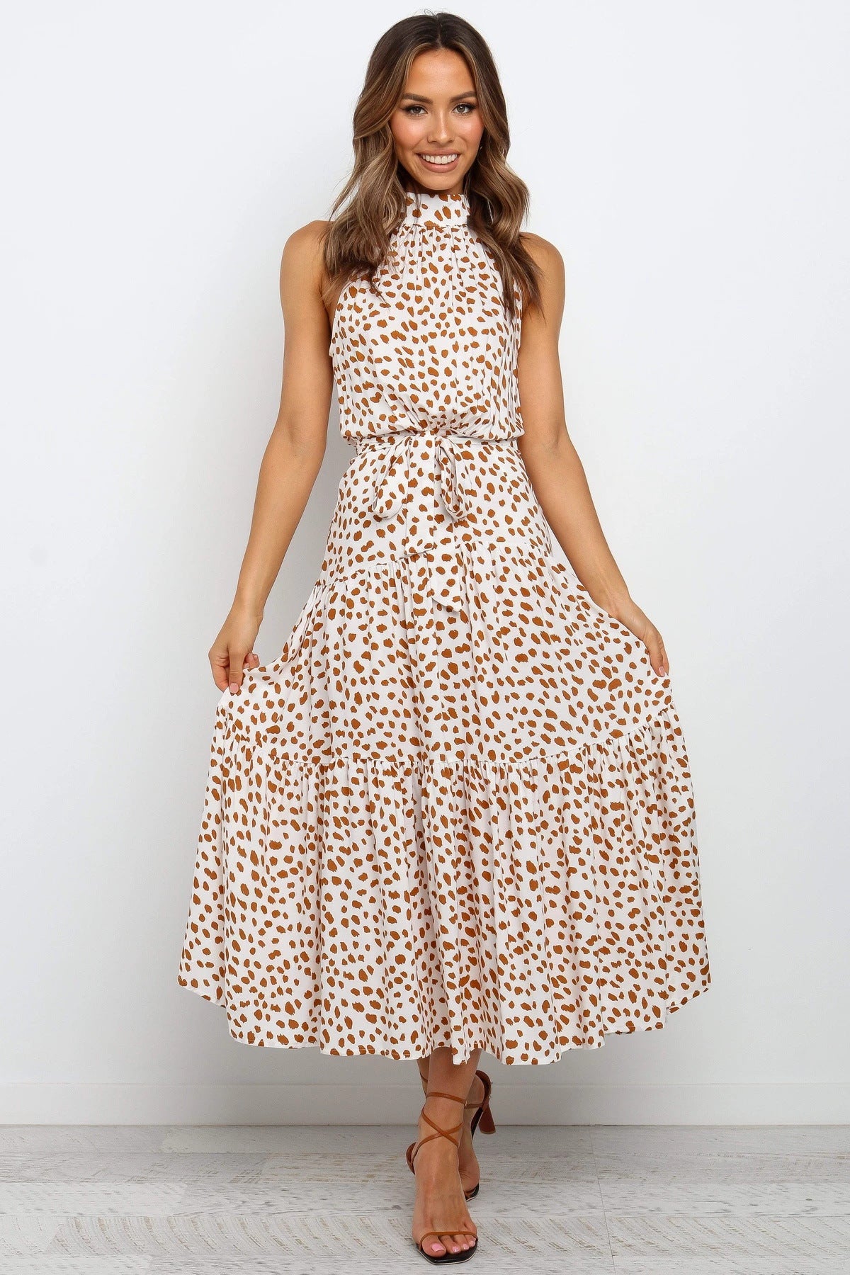 Cream sleeveless halter long dress with rust polka dots and tied waist