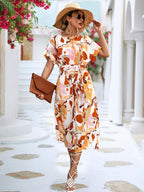 Orange and white abstract print maxi dress with short sleeves and tied waist