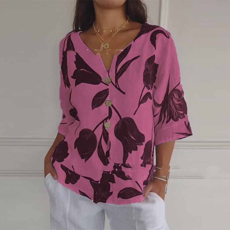Pink summer button-up shirt with dark floral leaf print, V-neck and 3/4 sleeves