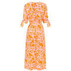 Orange leaf-print midi dress back view with tie cuffs and gathered waist