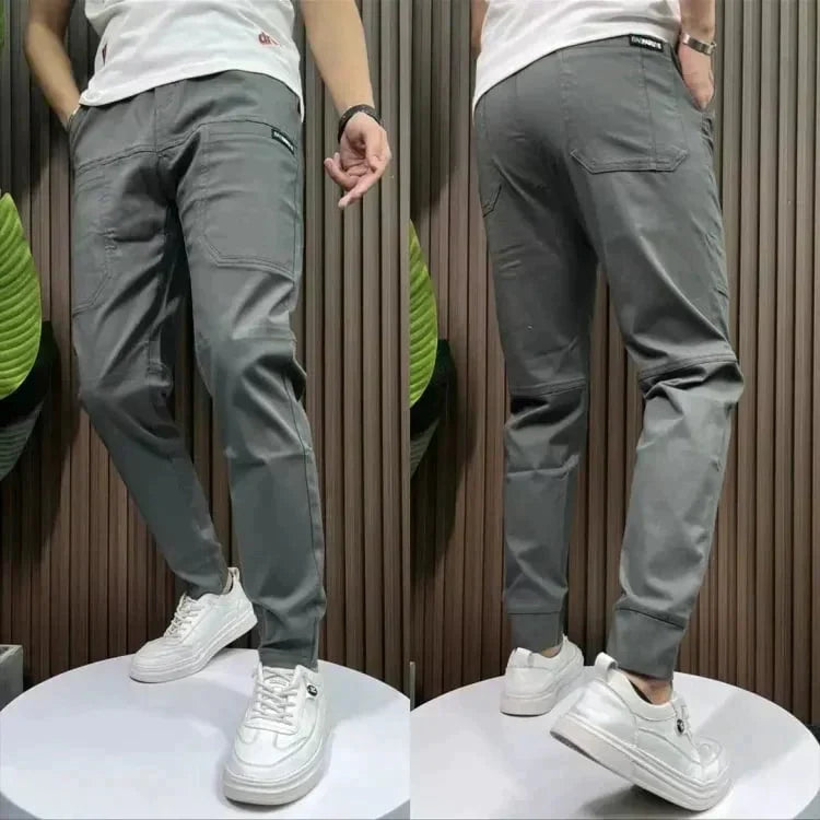 Men's dark gray casual pants with zip fly, tapered legs, side pocket detail