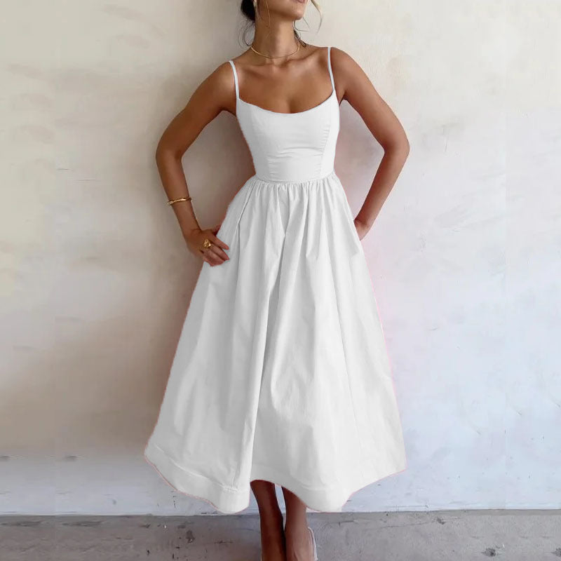 White sleeveless maxi dress with spaghetti straps and gathered waist full skirt