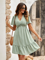 Light green short-sleeve V-neck tiered dress with small dot pattern and crochet yoke