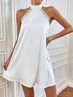 White halter mini dress with lace-trim high neck and flared hem