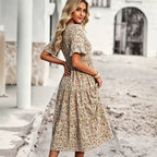 Floral V-neck midi dress in apricot with short puff sleeves and cinched waist, back view