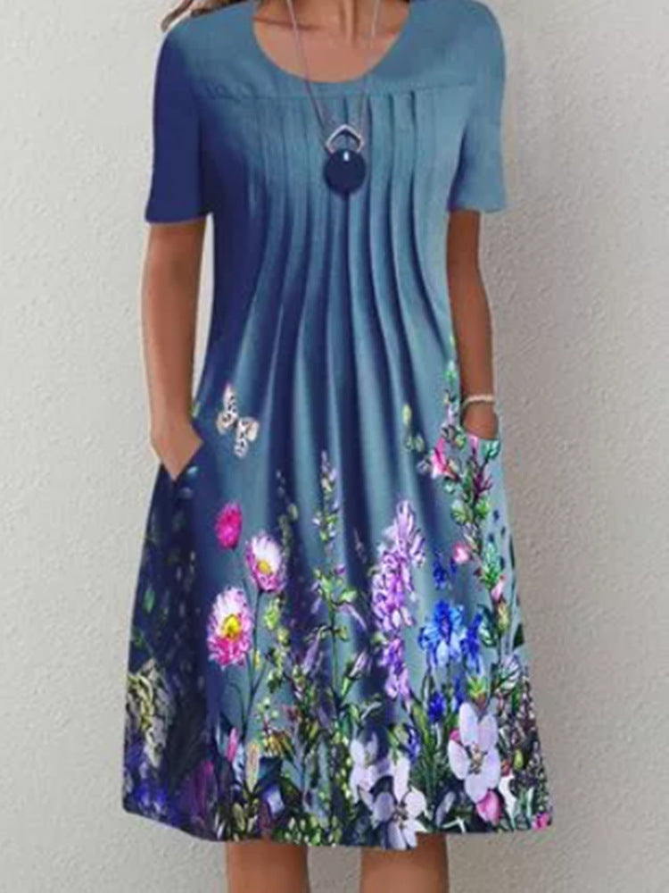 Casual floral dress in dusty blue with multicolor flower print, short sleeves, and keyhole detail