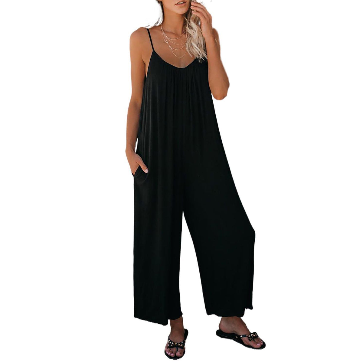 Black loose jumpsuit with thin straps and wide-leg silhouette.