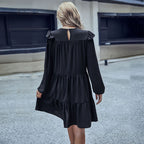 Black tiered mini dress back view with open V-back and ruffled shoulder details