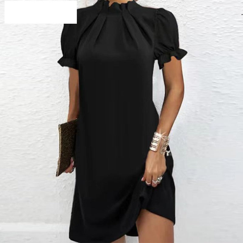 Black gathered-neck dress with short puff sleeves and flowing drape, above-knee length
