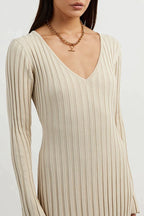Beige V-neck midi dress detail view with long sleeves and fine vertical stripes