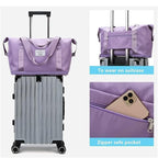 Purple waterproof sleeping bag carrier, suitcase-style handles, zip pocket detail