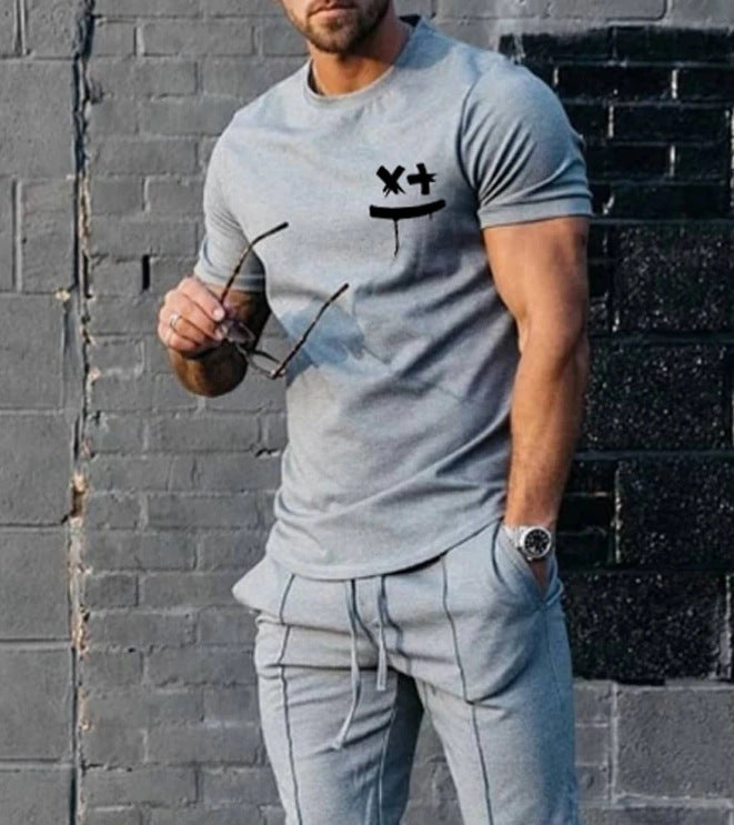 Light gray cotton t-shirt with black chest graphic and drawstring jogger pants, front view