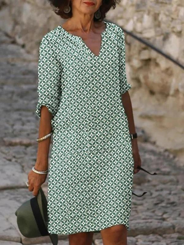 Green patterned V-neck shift dress with long sleeves, above-knee length