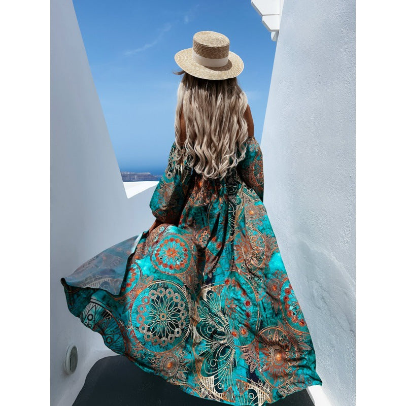 Turquoise teal maxi dress with long billowy sleeves and full skirt, ornate circular pattern