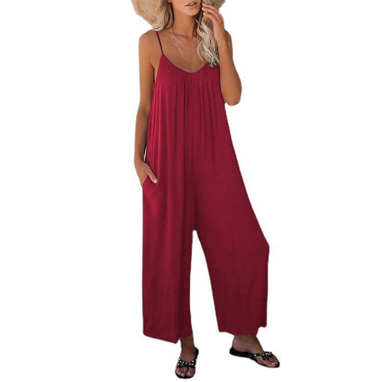 Red loose jumpsuit with thin straps and wide, flowing pant legs.