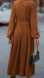 Brown midi dress back view with pleated skirt and long sleeves