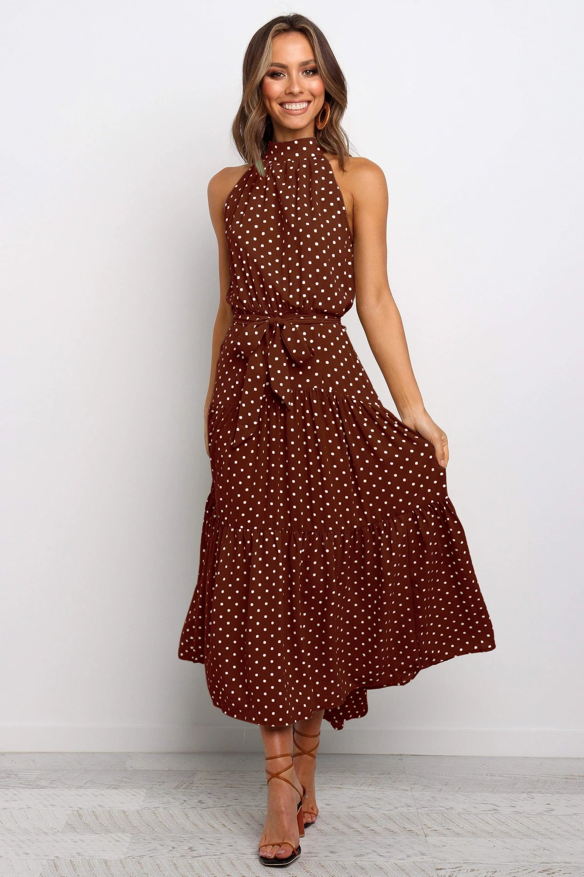 Brown sleeveless halter long dress with white polka dots and tied waist