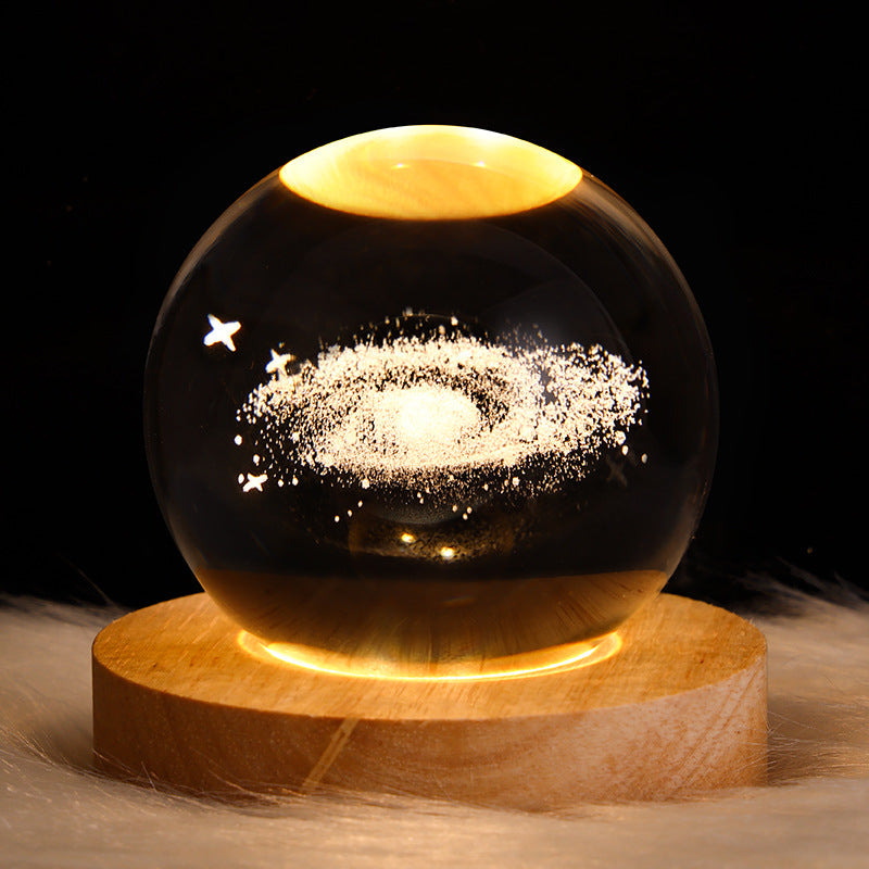 Luminous crystal ball with glowing starburst light pattern on a wooden base