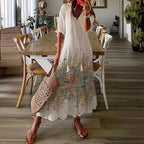 White boho maxi dress with subtle multicolor floral print and gathered tiers