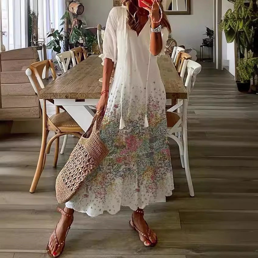 White boho maxi dress with subtle multicolor floral print and gathered tiers