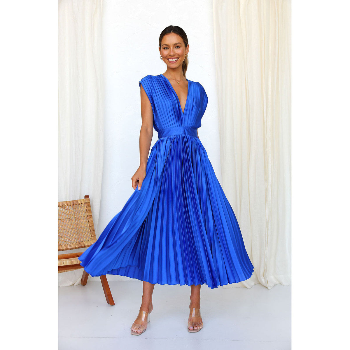 Bright blue pleated V-neck dress with cap sleeves and cinched waist