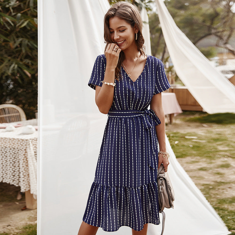 Navy blue striped midi dress with V-neck, short sleeves, tiered hem, and waist tie
