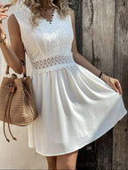 OTA elegant mini dress in white with scalloped lace V-neck and gathered skirt