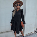 Black tiered long-sleeve mini dress with ruffled neckline and gathered skirt tiers