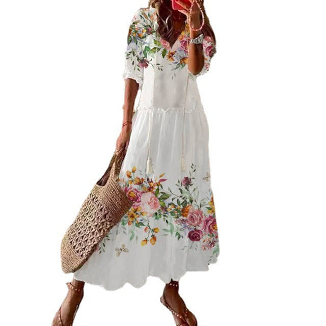 White boho maxi dress with floral print, short puff sleeves, tiered skirt