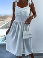 White midi summer dress with tie shoulder straps, button-front bodice and gathered skirt