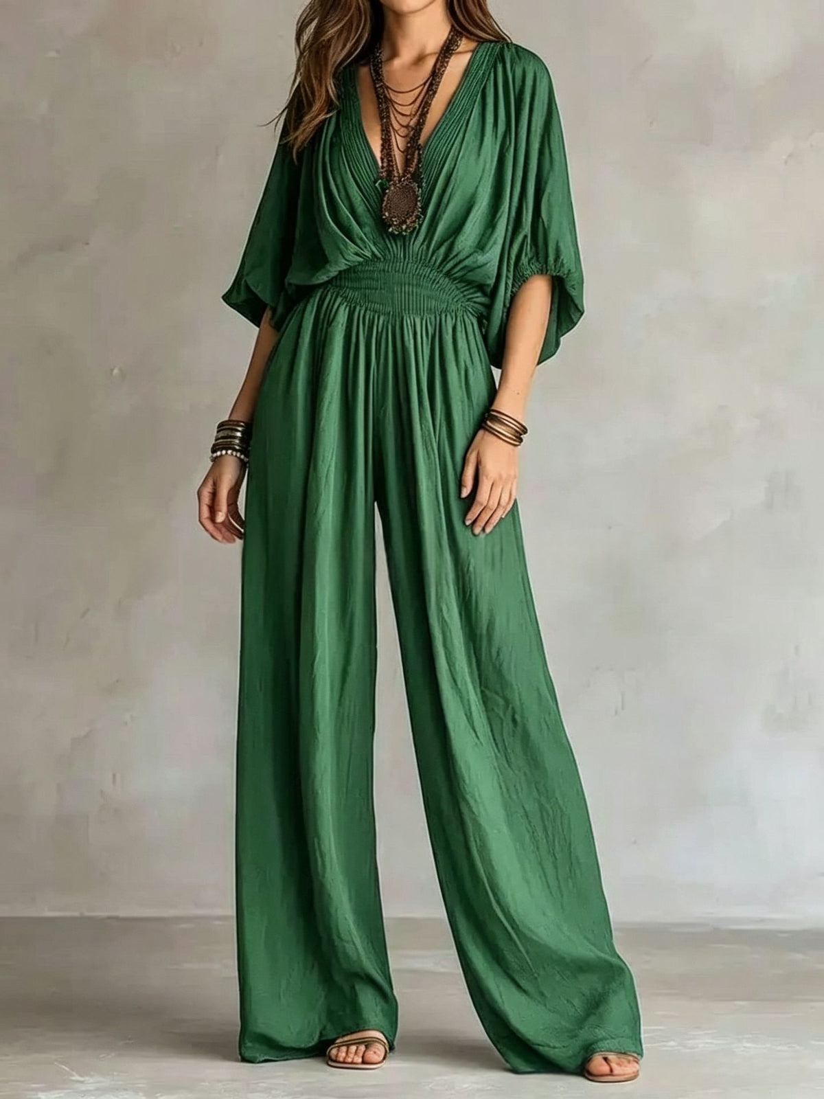 Green V-neck wide-leg jumpsuit with elastic waist and draped short sleeves