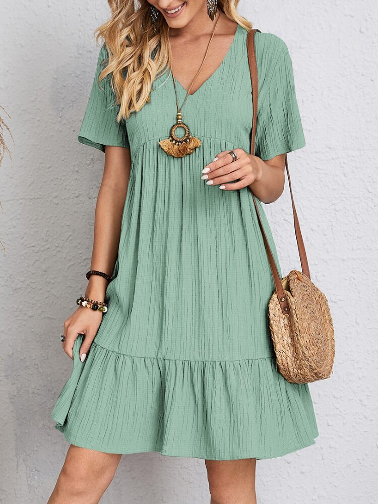 Teal V-neck short-sleeve tiered dress with gathered waist detail.