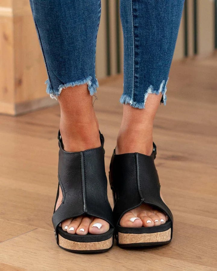 Women's black open-toe wedge sandals with ankle strap and stud details