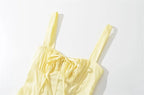 Light yellow dress top view with spaghetti straps and ruched neckline detail