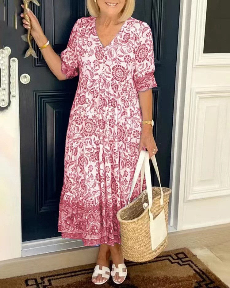 BRONYA V-neck midi dress in pink floral print, short sleeves, tiered skirt.